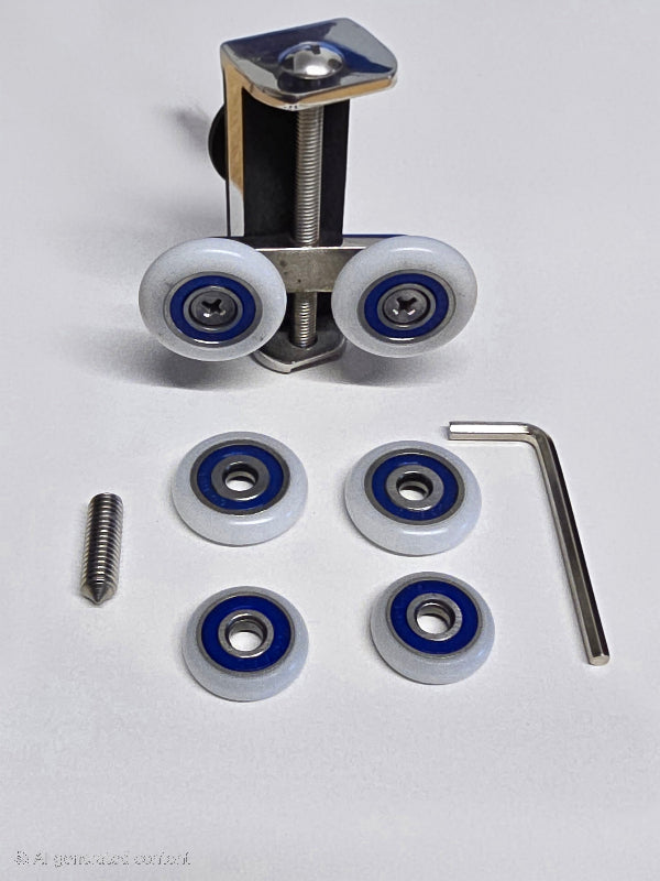 Set of Uniwheel sliding door rollers with wheels and installation tool on a white background