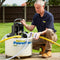 A Person using Fernox F8 in a power flushing machine